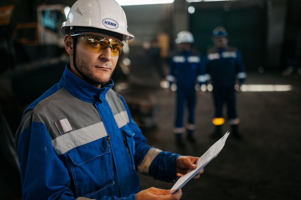Auditor with documentation inside a manufacturing plant