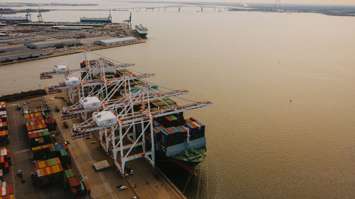 Port cranes loading containers onto a vessel