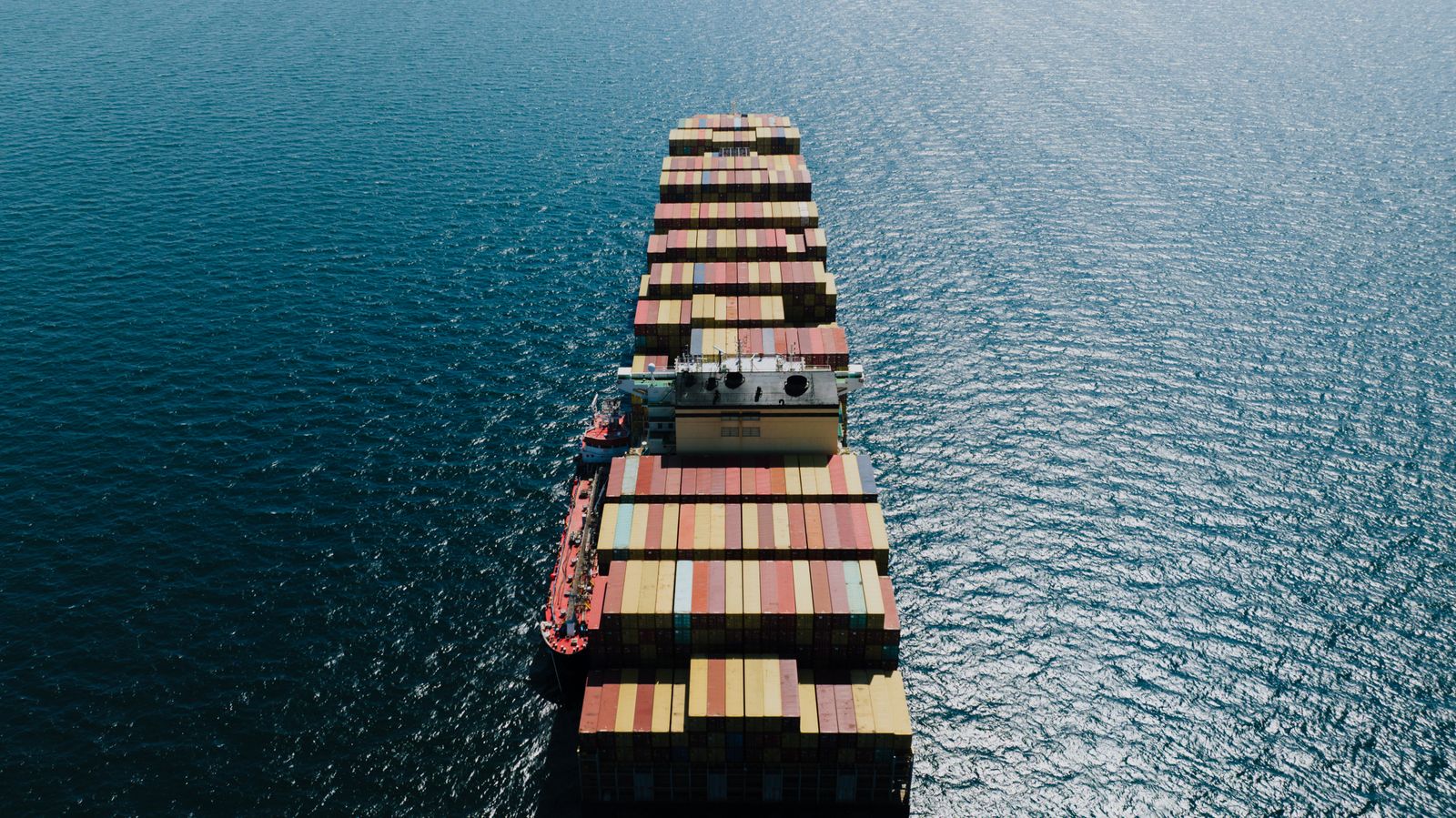 Container vessel crossing open sea, seen from above